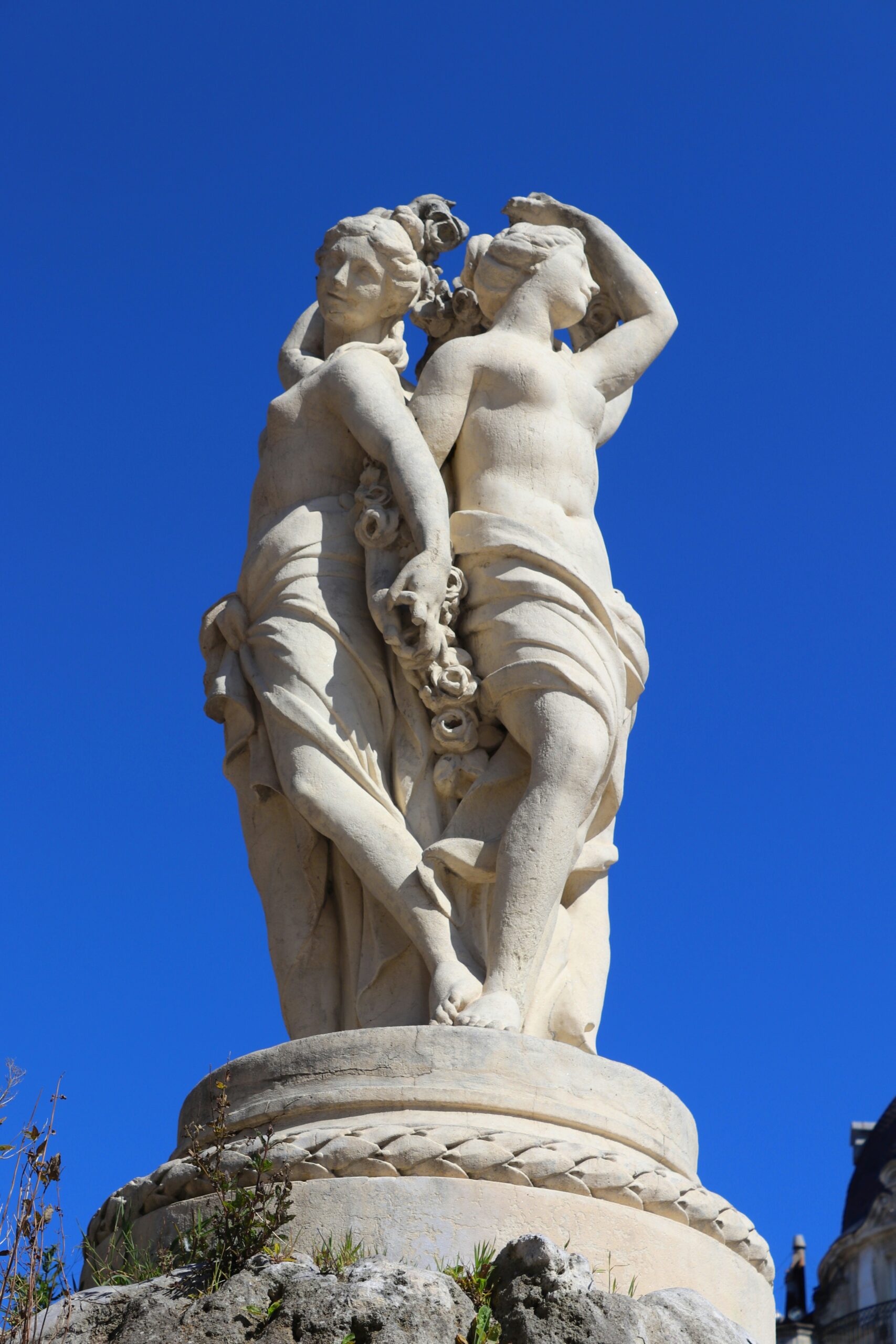 a statue of two women holding each other